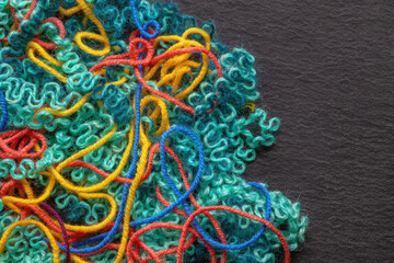 Colorful tangled threads on dark background. Mess and problems concepts. Copy space