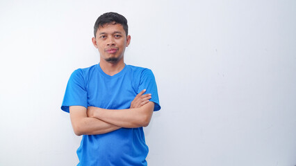 Portrait of asian man crossed arms wearing blue t-shirt isolated on white background