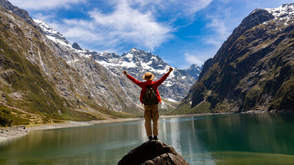 Happy time with  sucessful of young man on the top of mountain near the lake side view