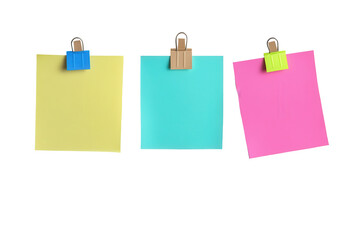 Colorful sticky notes clipped on a board with vibrant colors in a workspace setting perfect for reminders and organization