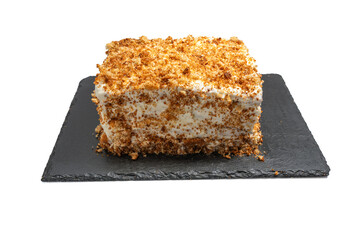 Slice of cake with whipped cream and crumbs, photographed from above. Isolated on a white background.