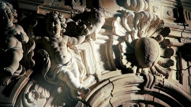 Stone cherubs and floral carving, architectural detail, ornate art. - Powered by Adobe