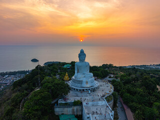 aerial view bright yellow sun in sunrise at Phuket big Buddha. the sun breaks through the clouds...