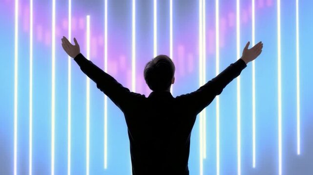 Silhouette of Triumph: Silhouette of a man standing with arms raised in front of a vibrant neon light display, symbolizing triumph and limitless potential.