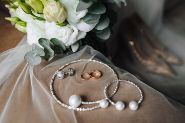 Wedding photo close-up of accessories, details of the bride: white long veil, bouquet of fresh...