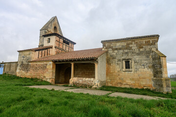 Fototapeta premium Historic Church of San Miguel with stone walls and bell gable in Villavega de Ojeda
