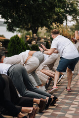 A fun, funny photo of men dancing at a gay party.