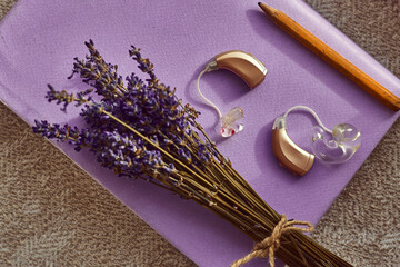 Colorful hearing aids await amid fragrant lavender and a pencil, inspiring connection and creativity