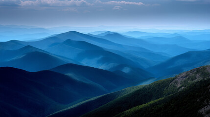 Obraz premium Mountain ridges forming a zigzag pattern, each layer darker in the foreground and lighter toward the horizon.