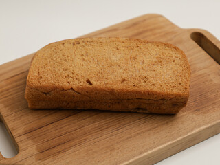 Loaf bread with cream filling on wooden cutting board