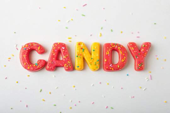 The Word CANDY Formed by Colorful Frosted Cookies with Sprinkles candy letter