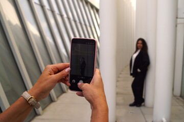 woman taking a photo of a woman on her phone