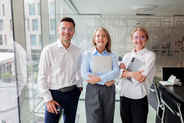 Three professionals seamlessly collaborating in a modern office environment with sleek design...