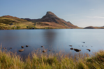 Cregennan Lakes in North Wales, UK, with heather on the mountains