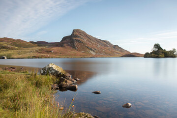 Cregennan Lakes in North Wales, UK, with heather on the mountains