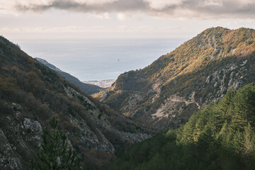 Autumn mountain landscape with sea view in distance