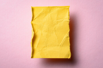 One single yellow torn ripped wrinkled crumpled blank paper note with drop shadow, folded edge and...