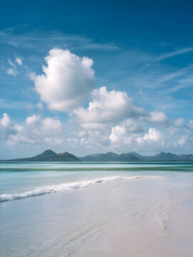 Calm ocean waves gently rolling onto a white sandy beach