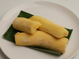 Tape Singkong or fermented cassava on banana leaf and white background