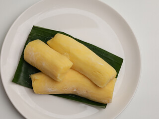Tape Singkong or fermented cassava on banana leaf and white background