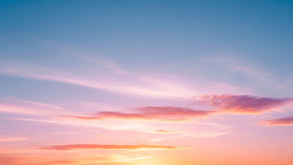 Obraz premium A high-definition photograph of a sky-themed background, featuring a smooth gradient of soft pastel colors, transitioning from a warm, golden orange at the horizon to a calm blue at the top