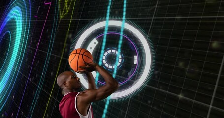 The african american male basketball player is holding a basketball against a black background - Powered by Adobe