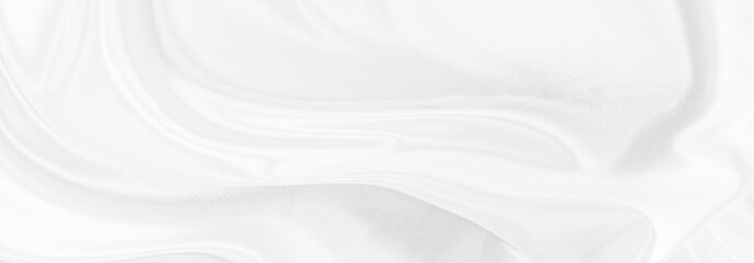 White gray satin texture that is white silver fabric silk panorama background with beautiful soft blur pattern natural.