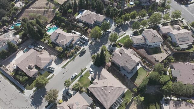 Paso Robles Suburban Neighborhood Aerial &mdash; Drone orbit of hillside homes with swimming pools and solar panels in Central California