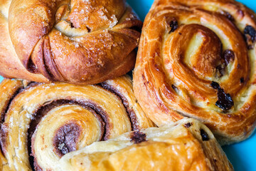 Selection of Breakfast Pastries Cinnamon Bun,Pain Aux Raisin, Pain Au Chocolate, Cinnamon Swirl