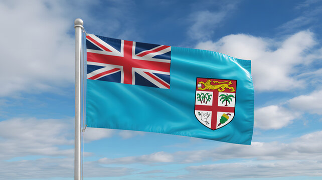 Fijian flag proudly waving on a flagpole against a bright blue sky with fluffy white clouds