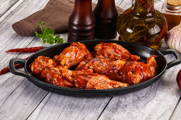 Raw marinated buffalo chicken wings