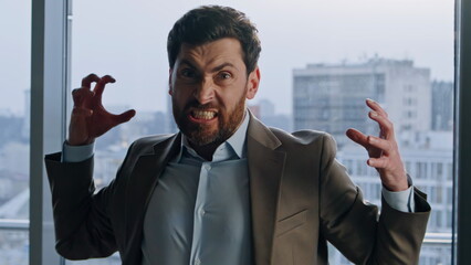 Furious manager demonstrating madness at windows office portrait. Emotional man
