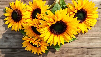 Obraz premium A vibrant sunflower arrangement on a rustic wooden surface, bathed in natural warm light.