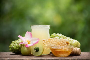Noni fruits extracted with water, mixed with Indian gooseberry and honey for healthy drink on...