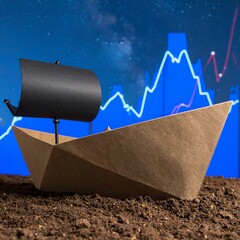 A paper boat rests on soil, against a backdrop of financial charts