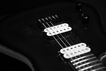 Electric guitar detail shot of strings and humbucker pickups