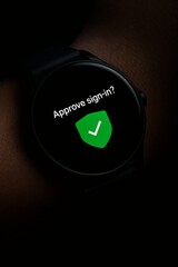 Smartwatch Macro Displaying Multi-Factor Authentication Prompt with Green Shield Checkmark on Black Background