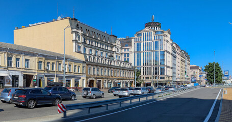 City street with intensive traffic. Buildings of different eras receding into the future. Architecture as real estate, commercial and residential. Dynamic composition of city rhythm.