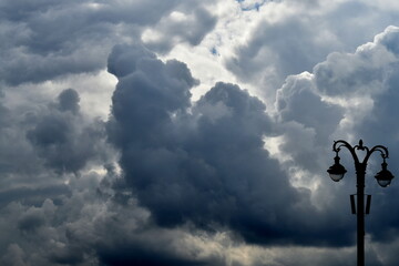 street lamp against cloudy sky