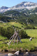 A tranquil summer day in Pirin National Park, Bulgaria, showcasing majestic snow-capped peaks and...