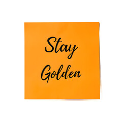 Motivational Stay Golden message on an orange sticky note in elegant cursive handwriting Ideal for positive concepts and office inspiration, isolated