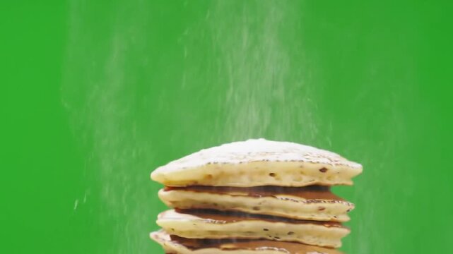 Pancake Stack with Powdered Sugar Falling on Green Screen Background