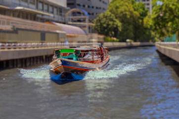 Ferry boat going through a Canal Khlong in Thai running from Soi 15 Sukhumvit Rd NANA to Siam and...