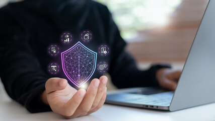 Businesswoman holding digital shield icon for financial data protection, representing...
