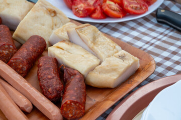 Tray of sausages, bacon and tomato