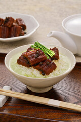 Hot green tea is poured over cooked rice topped with eel simmered in sweetened soy sauce. Japanese cuisine