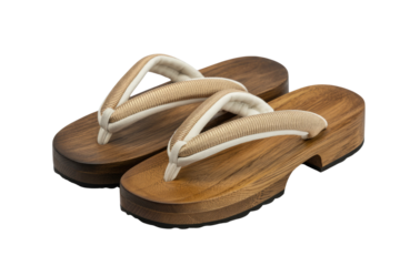Pair of elegant geta sandals with wooden base and gold-trimmed off-white straps. background removed