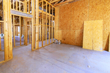 Wooden frames are outlined within spacious construction site, beams frame of upcoming development.