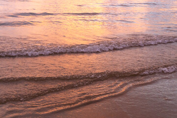 beach waves glowing under sunset