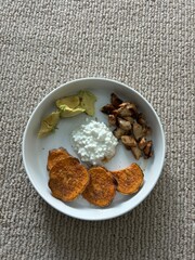 sweet potatoes, avocado, grilled chicken, cotage cheese dinner on white plate 